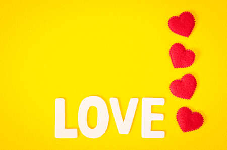 Love word and red heart with empty space on yellow background.の写真素材