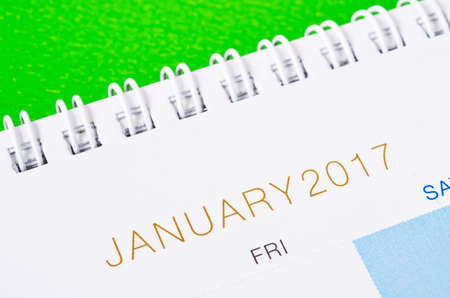 Desk top calendar January 2017 close up on green background.の写真素材