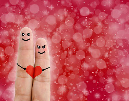 Painted finger smiley, Happy valentine's day concept on red background.の写真素材
