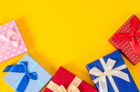 Many color gift box on yellow color background with empty space.の写真素材