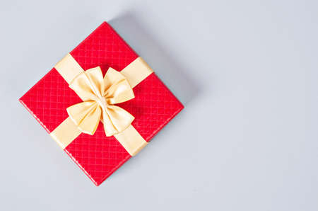 Red gift box on gray color background with empty space.