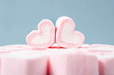 Heart shape marshmallows on heap of pink marshmallows.の写真素材