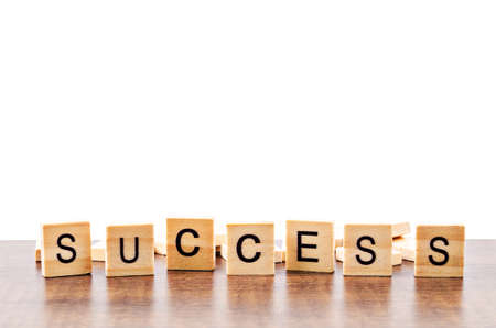 Success word wood on table, Isolated on white background with copy space. Save clipping path.の写真素材