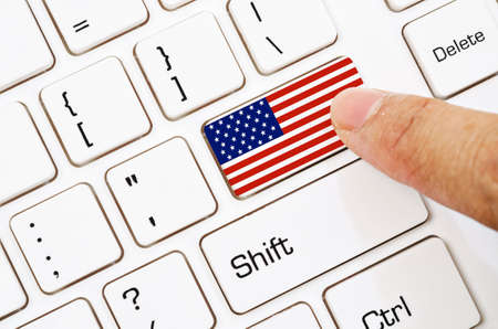 Hand press Computer keyboard with the US flag on it.の写真素材