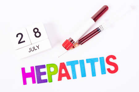 28 July calendar wood and sample blood with hepatitis wooden letters word. World hepatitis day...