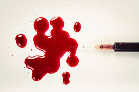 A syringe with blood.の写真素材