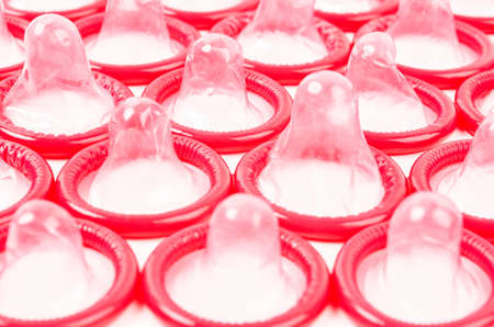 Red Condom isolated on white background.の写真素材