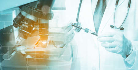 Man Doctor with blood test on microscope lab background, Laboratory research concept.の写真素材