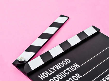 Blank movie production clapper board or slate film over pink background with copy space.の写真素材