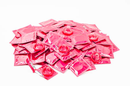 Heap of pink condoms pack isolated on a white background.の写真素材