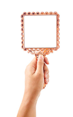 Beautiful vintage mirror for makeup in woman hand isolated on white background, Save clipping path.の写真素材