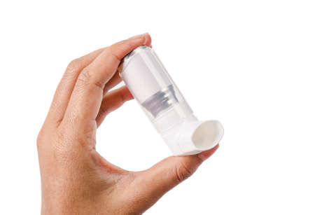 Hand holding asthma inhaler isolated on a white background. save clipping path.