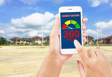 People using smartphone about credit score for buy real estate. On housing blur background.