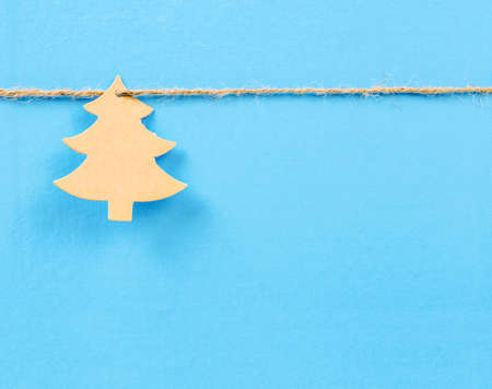  paper christmass tree on blue background.