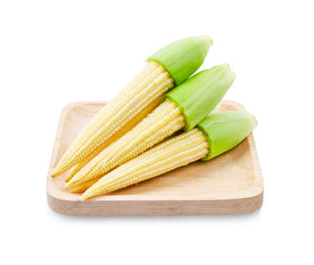 Fresh baby corns in wooden dish isolated on white background, Save clipping path.の写真素材
