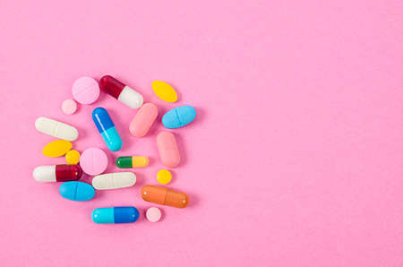 Pills and capsules on pink backgroundの写真素材
