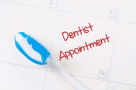 A note of a dentist appointment on a calendar reminds the patient.の写真素材