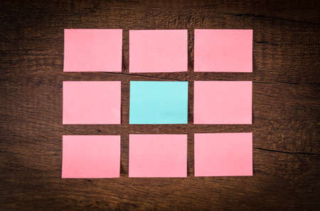 Blank many pink sticky notes for your text or message on wooden wall.