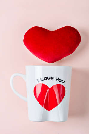 Valentine's Day Concept. Love cup with red heart on pink Background.の写真素材