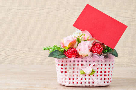 Blank red card for valentine with rose on wooden background.の写真素材