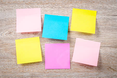 Blank colorful sticky notes on wooden background.の写真素材