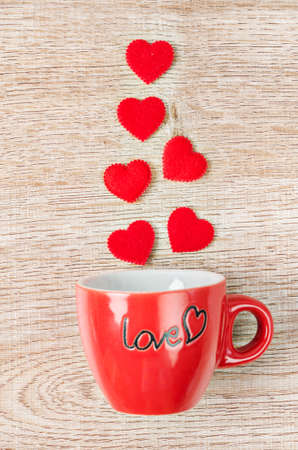 Red heart with red coffee cup on wooden background.の写真素材