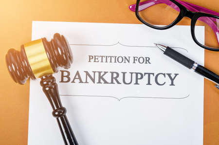 Bankruptcy document with wooden judge gavel and pen, glasses. Business concept.の写真素材