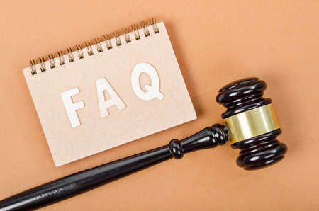Frequently Asked Questions with judge hammer. FAQ Law concept.
