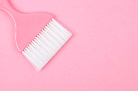Pink brush for cleaning on pink background.の写真素材