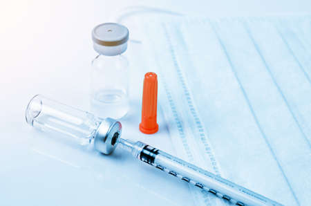 Medicine bottle for injection and medical surgical mask in laboratory.の写真素材