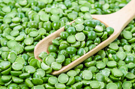 Green dry peas with wooden spoon. Cooking ingredient.の写真素材