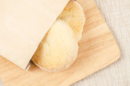 Bread and butter sweet in paper bag on wooden.