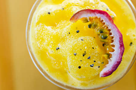 Passion fruit smoothie with passion fruit sliced in glass.の写真素材
