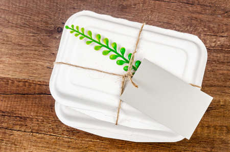 Biodegradable food box with blank tag for your text or message. Eco friendly concept.