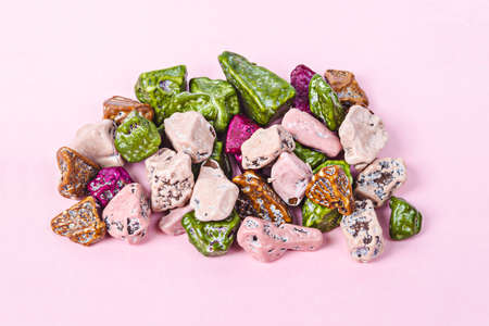 Heap of chocolate candy stones on pastel pink
