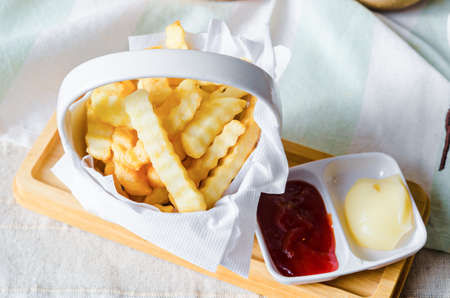 French fries and tomato dipping sauce on the table.