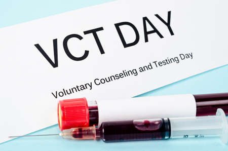 Voluntary counseling and testing day with blood in tube and syringe.