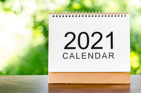 Calendar desk 2021 for organizer to plan and reminder on wooden table on nature background.の写真素材