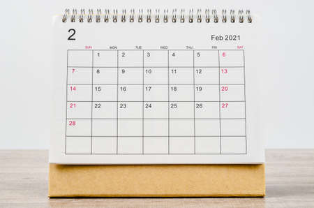 February 2021 Calendar desk for organizer to plan and reminder on wooden table.の写真素材