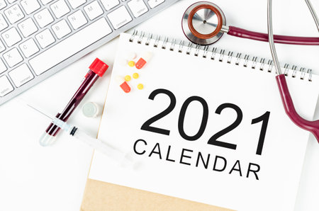 Calendar with stethoscope and sample blood in tube for test, Planing medical examination concept.の写真素材
