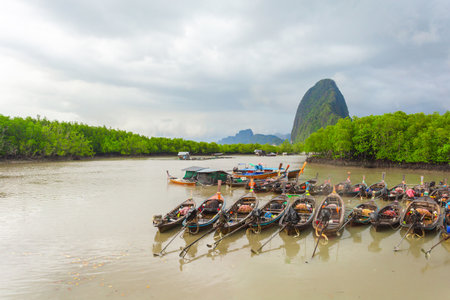 Wooden fishing boats in the sea with mountain background, Thailand.の写真素材