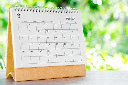 March 2021 Calendar desk for organizer to plan and reminder on wooden table on nature background.の写真素材
