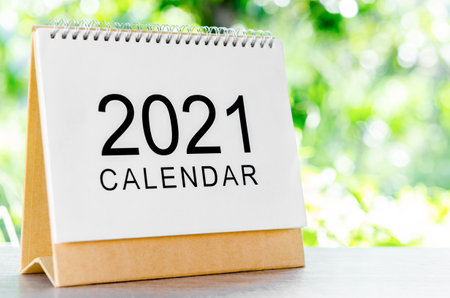 Calendar desk 2021 for organizer to plan and reminder on wooden table on nature background.の写真素材
