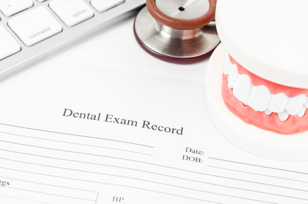 Dental exam record and model teeth with stethoscope medical on work table.の写真素材