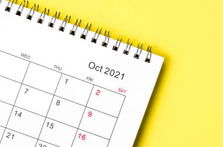 Close up October 2021 Calendar desk for organizer to plan and reminder on yellow background.の写真素材