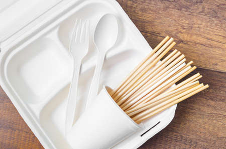 Eco friendly biodegradable paper disposable for packaging food with wheat straw for drinking water on wooden background.の写真素材