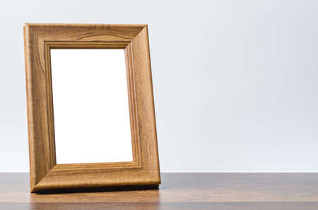 Blank wooden photo frame on table