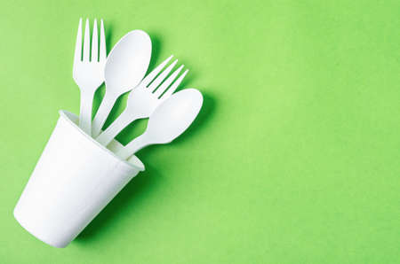 Eco friendly biodegradable paper disposable for packaging food and paper glass on green background.の写真素材