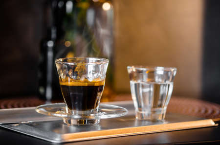 A cup of hot coffee with smoke in coffee shop.の写真素材