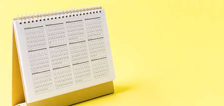 Desktop calendar 2021 on yellow background with empty space for your text or message.の写真素材